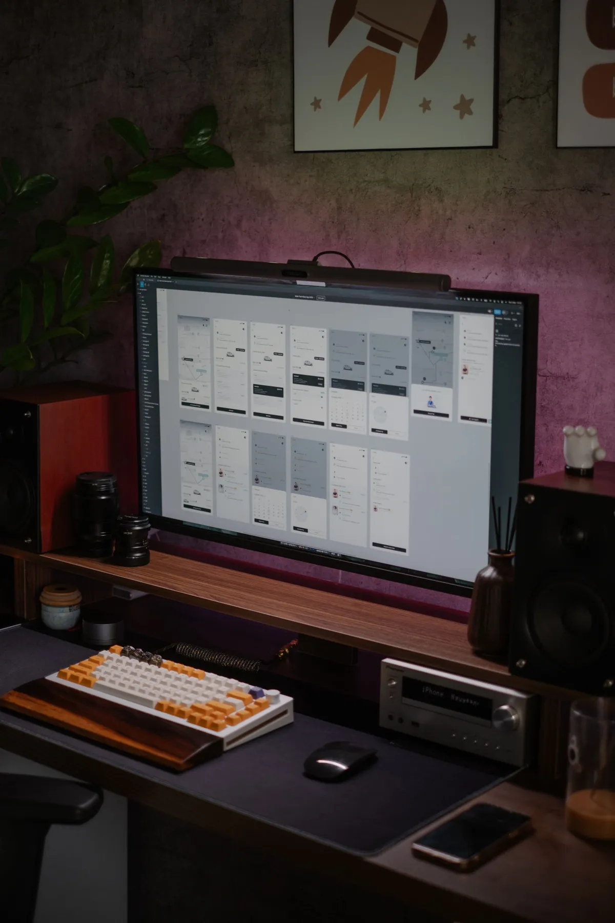A modern home office desk with a large monitor displaying user interface designs, representing an AI assisted Figma design workflow.