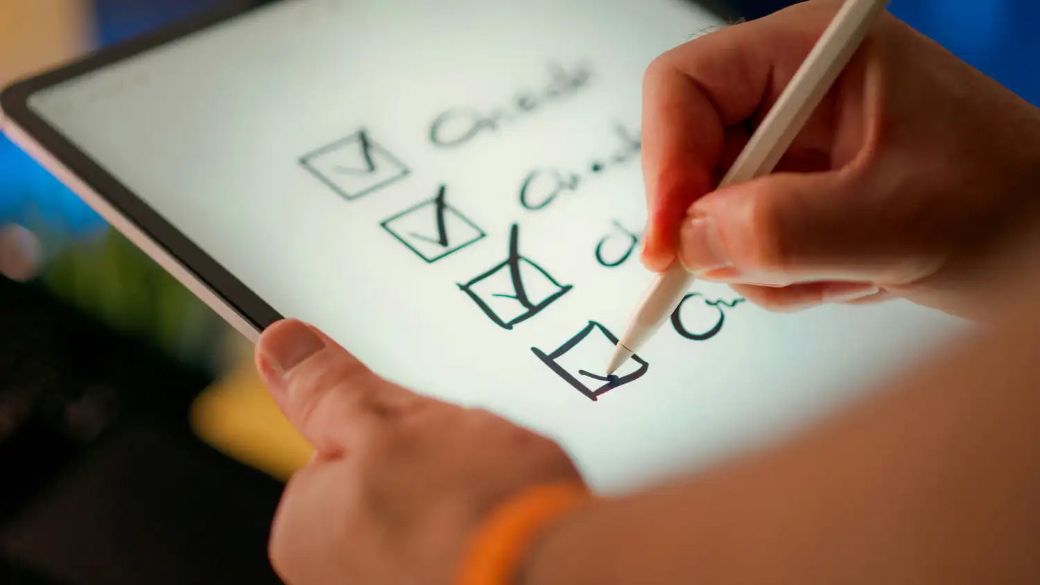 Hand using a digital stylus to check off a quality assurance task list on a tablet, highlighting the human-in-the-loop approach to professional web design.