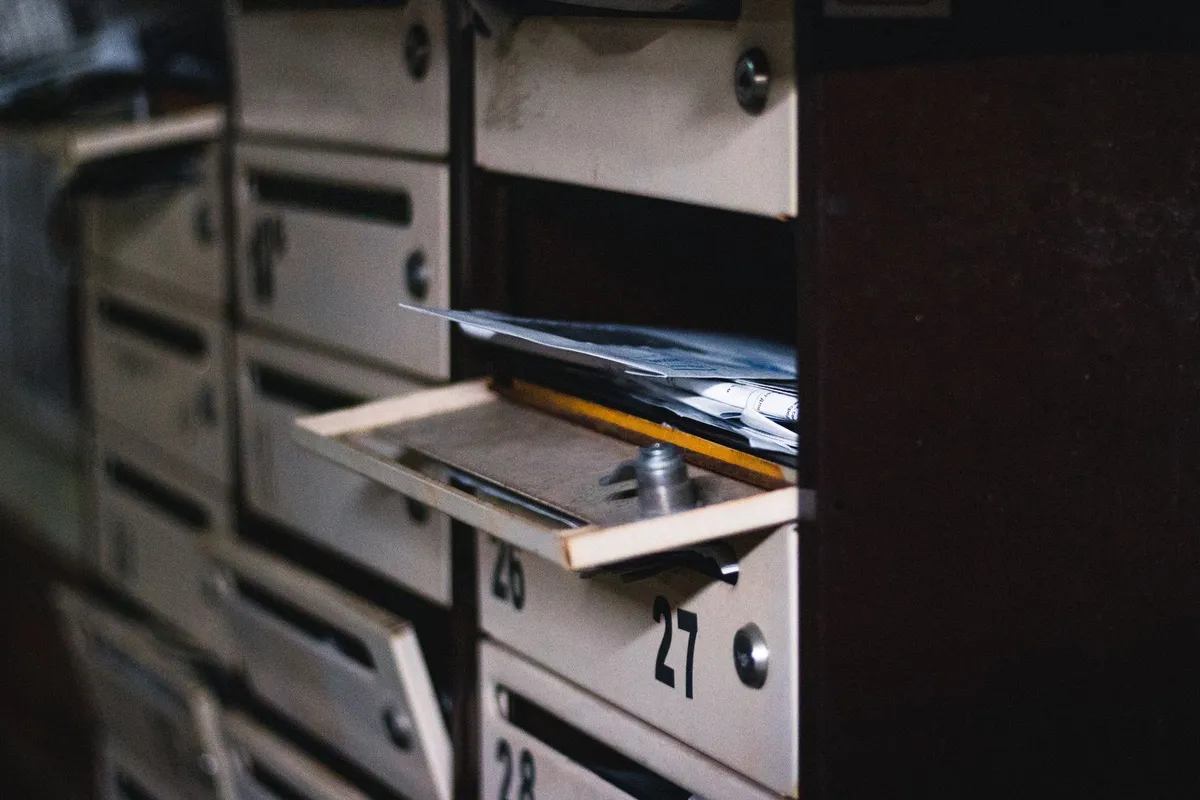 An open mailbox filled with unread letters, representing form submissions that stay stored in the Netlify dashboard when email notifications are disabled