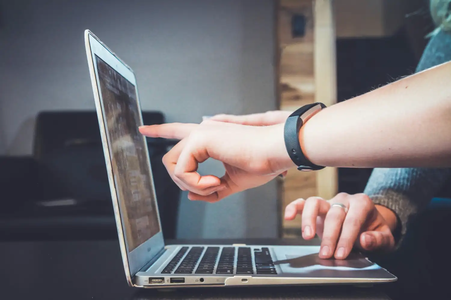 Professional web design collaboration showing two people discussing user experience strategies on a laptop to ensure premium project results.